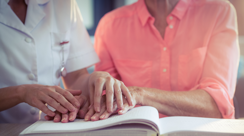 Woman learning Braille with a friend