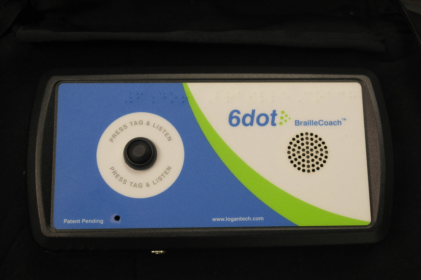 6dot BrailleCoach which is rectangular with a button to "press tag and listen" and circular speaker, and blue, green and white label with text "patent pending" and "www.logantech.com"