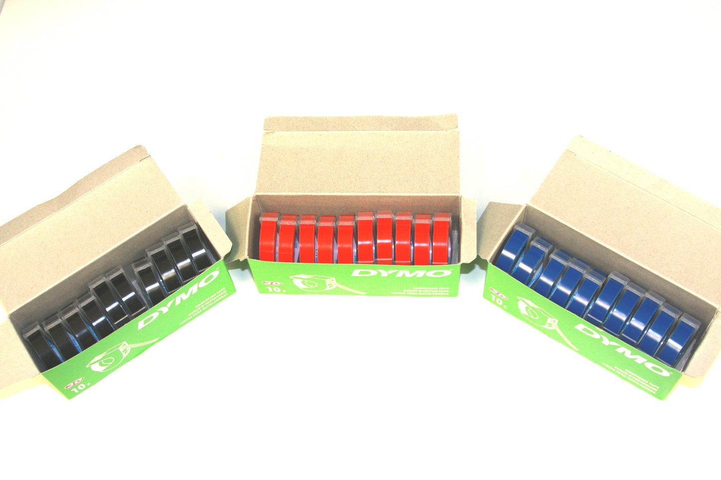 Open green box of black braille labeling tape, Open green box of red braille labeling tape, open green box of blue braille labeling tape. Each box has 10 rolls.